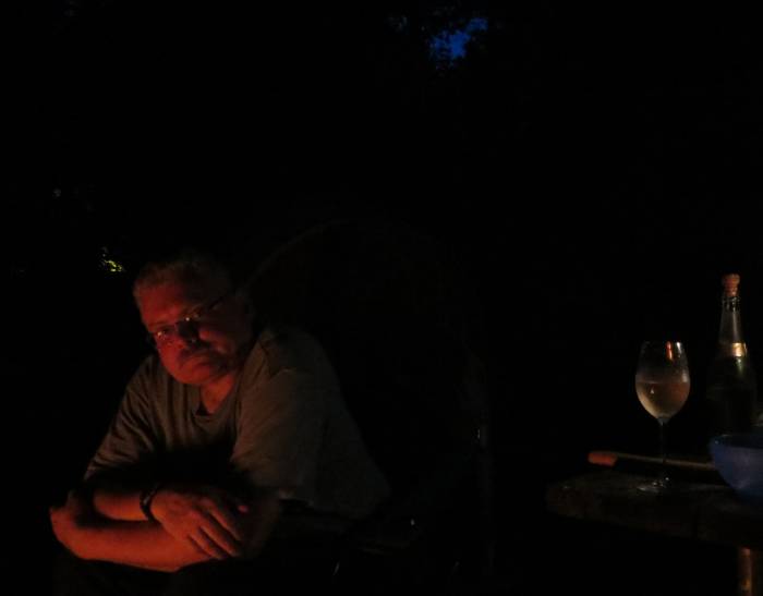 Paul at campfire with champagne